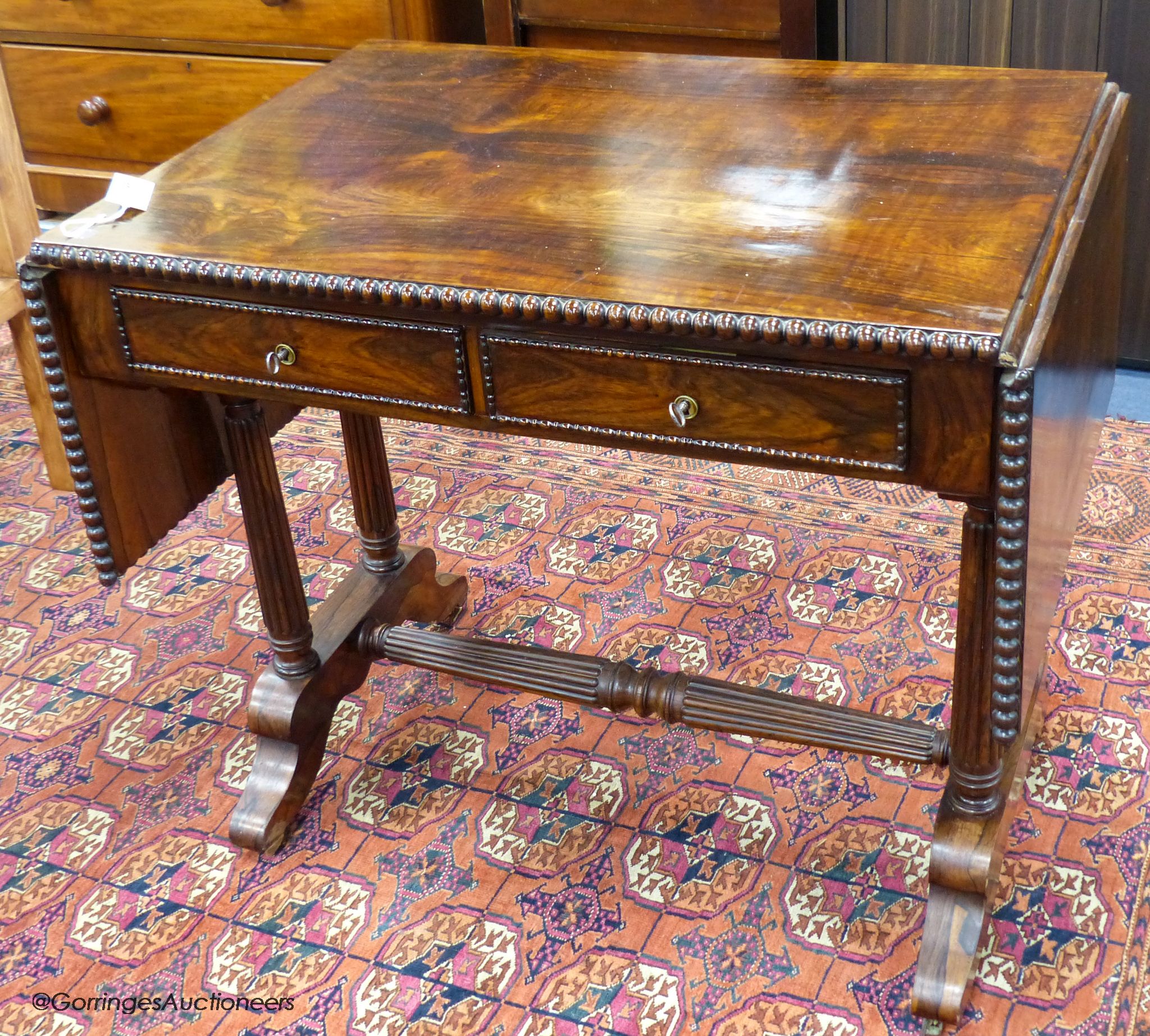 A 19th-century French rosewood sofa table, 86 cm wide with the leaves down, 61.5 cm deep, 75 cm high